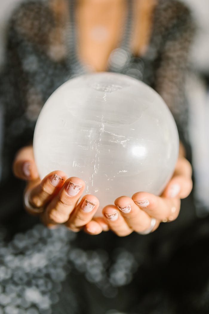 Mastering the First Impression: Your intriguing post title goes here Close-up of hands holding a clear crystal ball, ideal for spiritual or metaphysical themes.